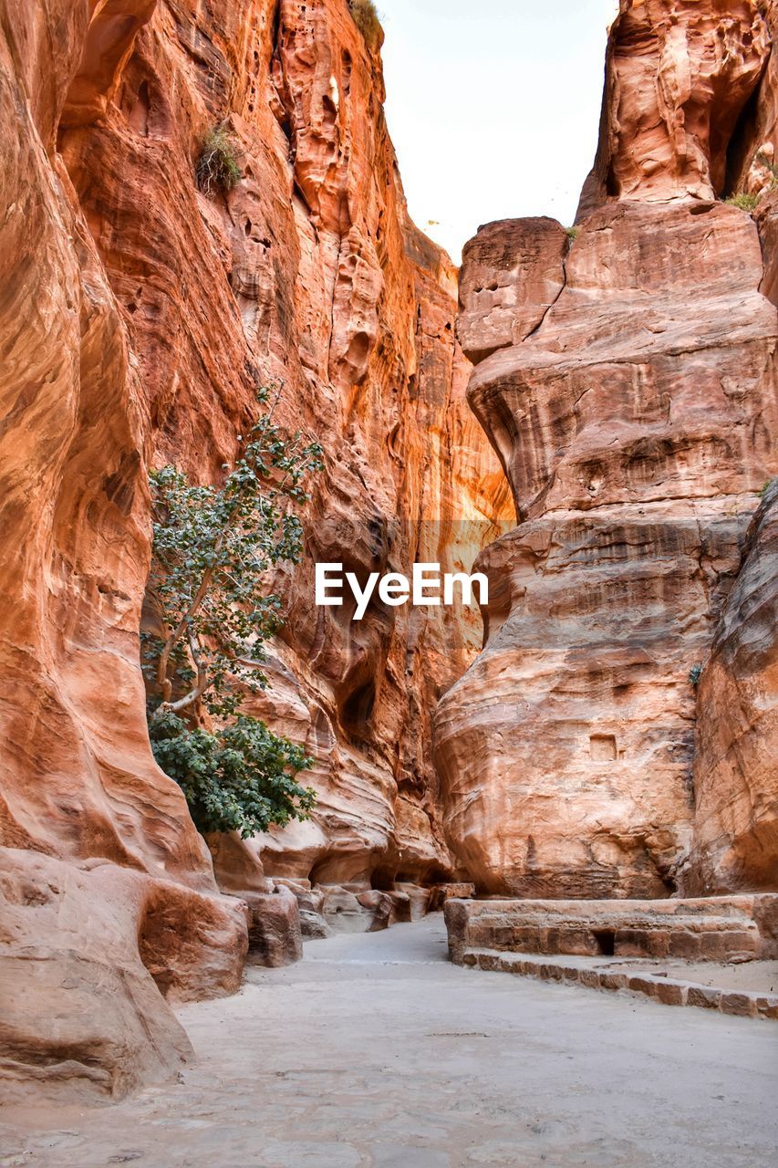 Low angle view of rock formation forming a warm orange canyon 