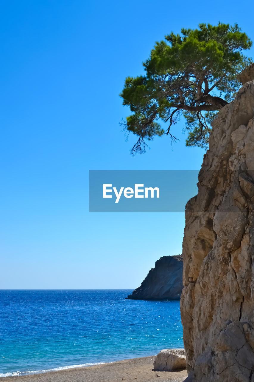 Scenic view of sea against clear blue sky