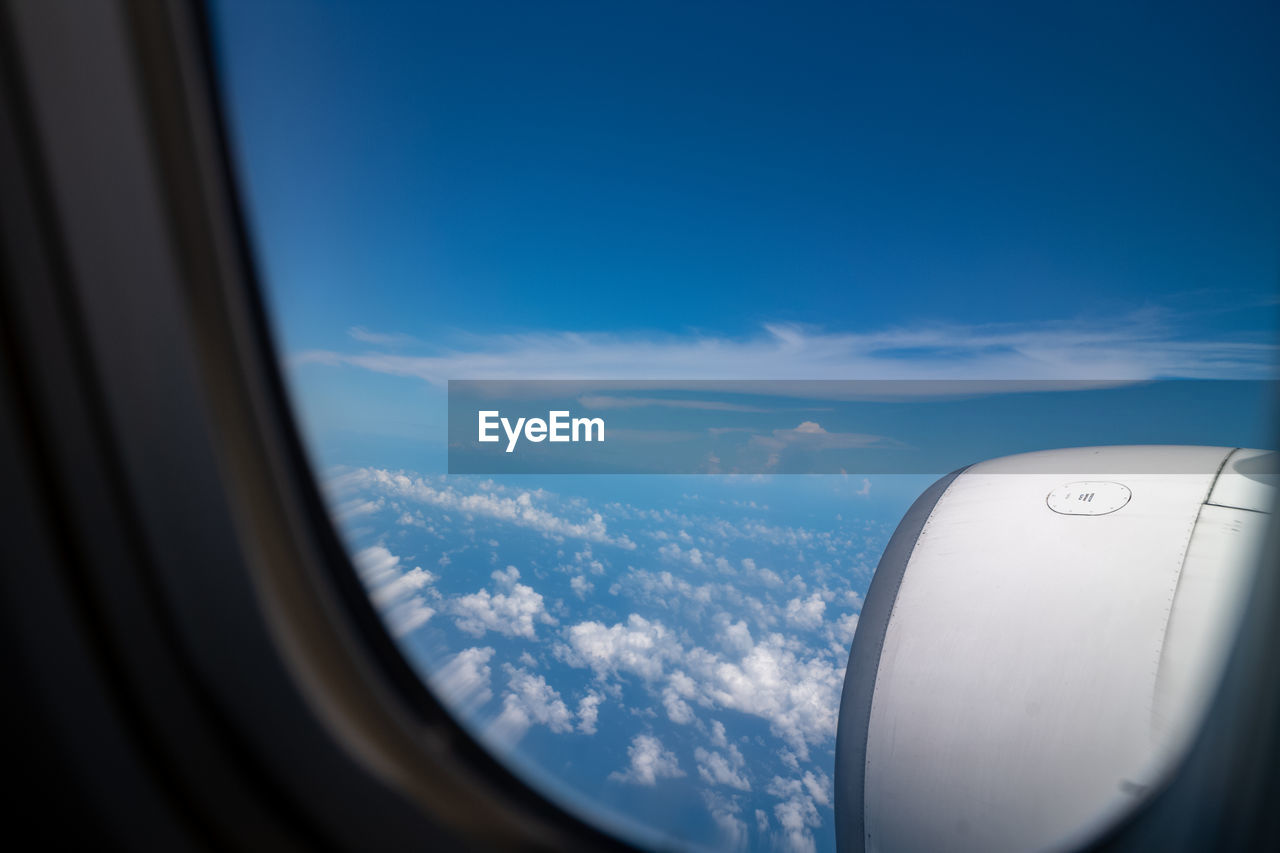 AIRPLANE WING SEEN THROUGH WINDOW