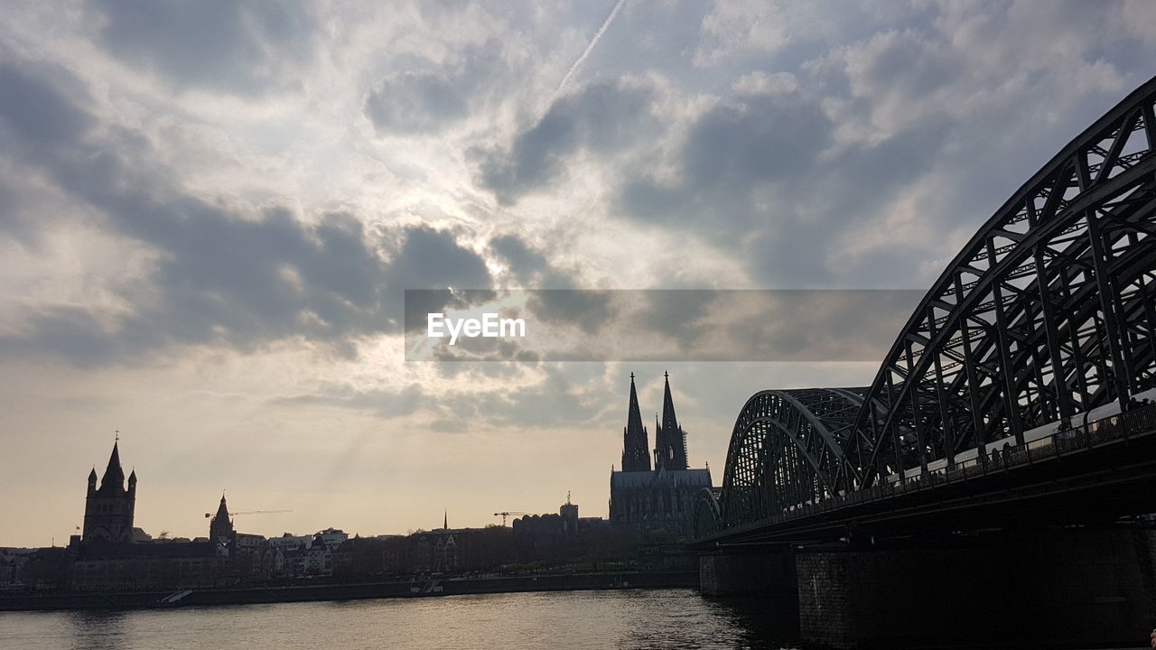 View of bridge over river against cloudy sky