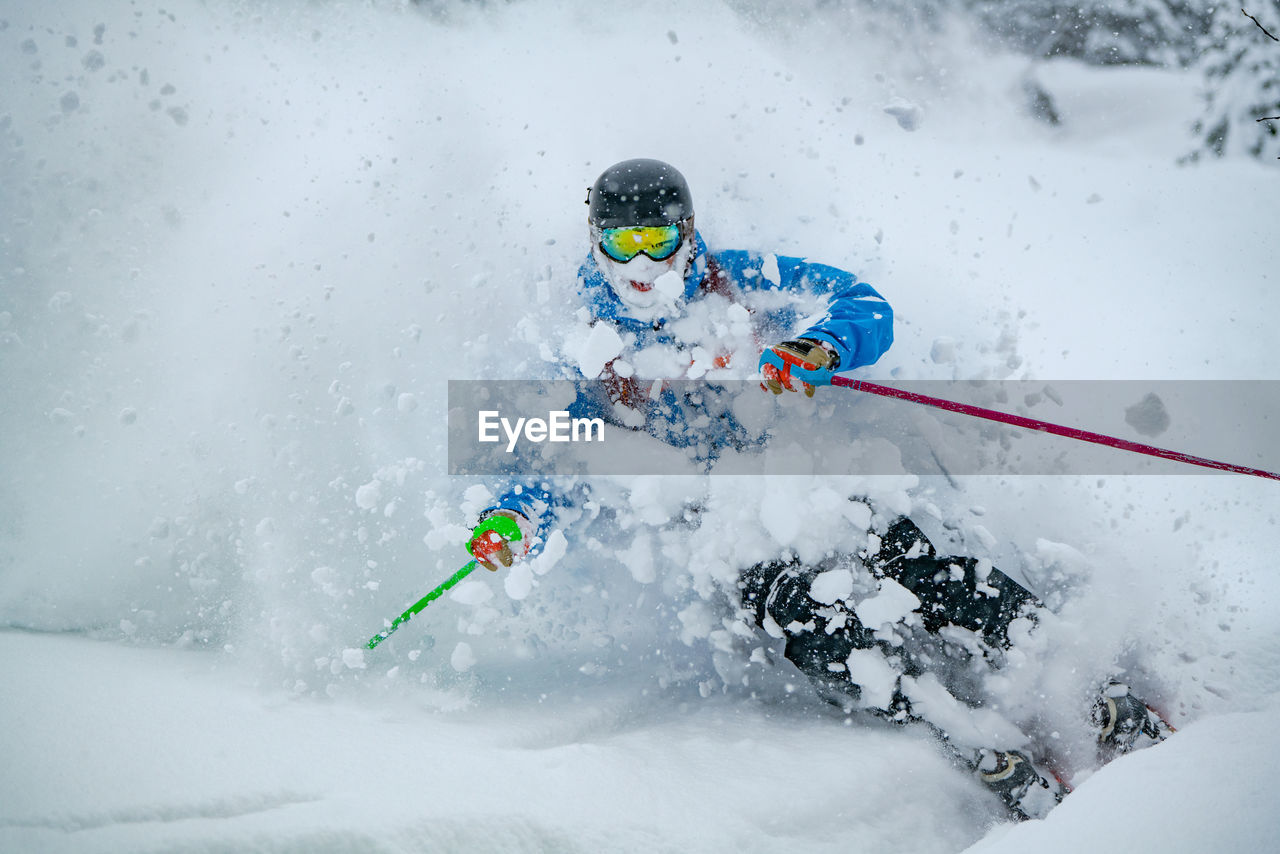 Adult man skiing in deep powder snow in the backcountry, werfenweng, austria.