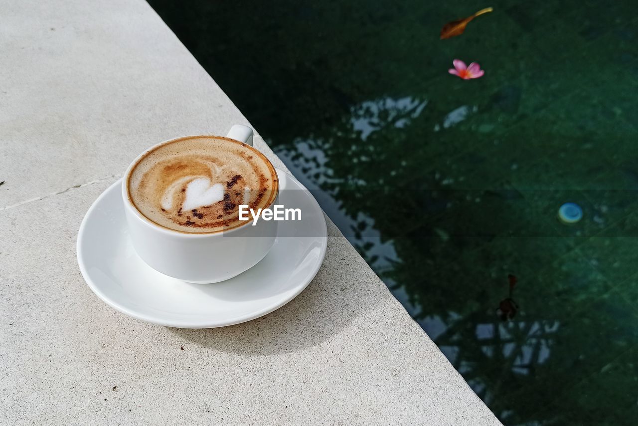 High angle view of coffee on pool side