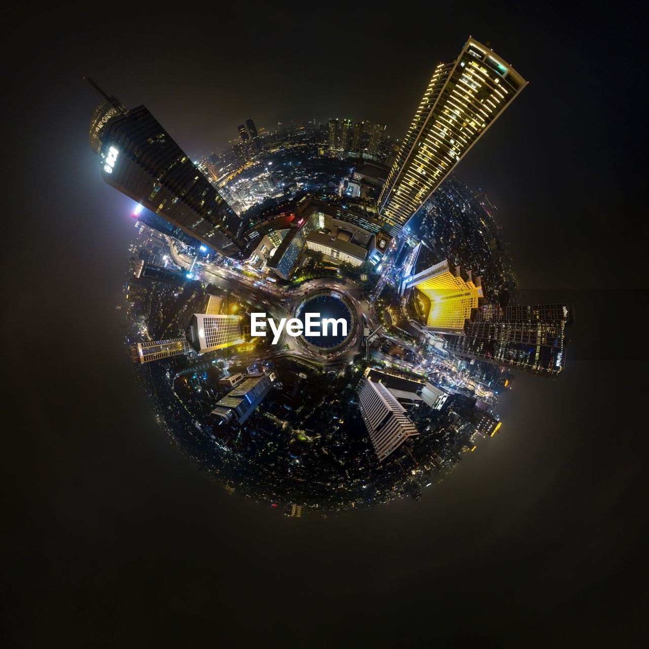 Digital composite image of modern buildings on globe against black background