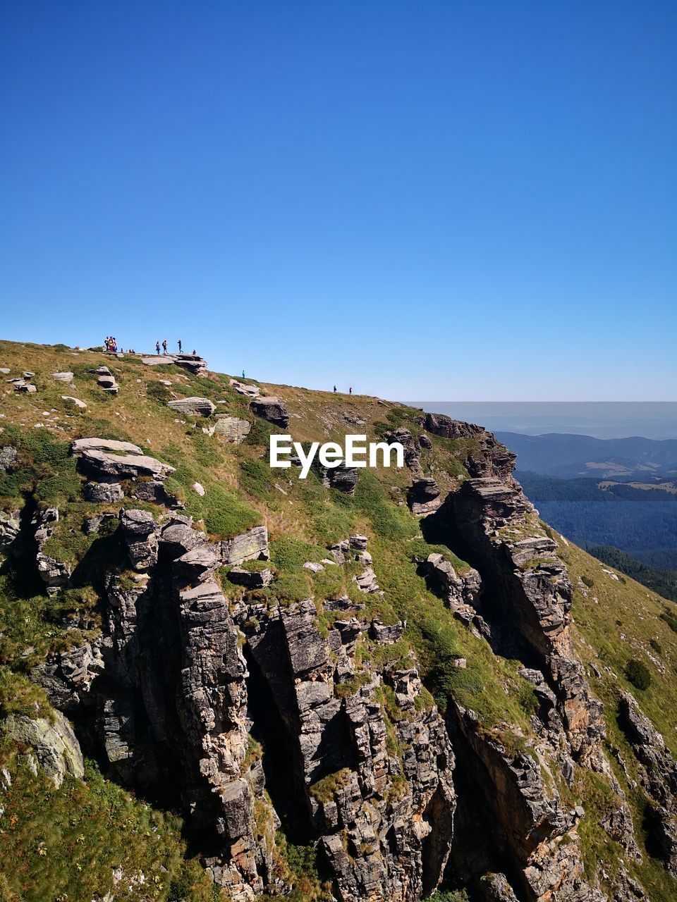 Scenic view of rocky mountains against clear blue sky