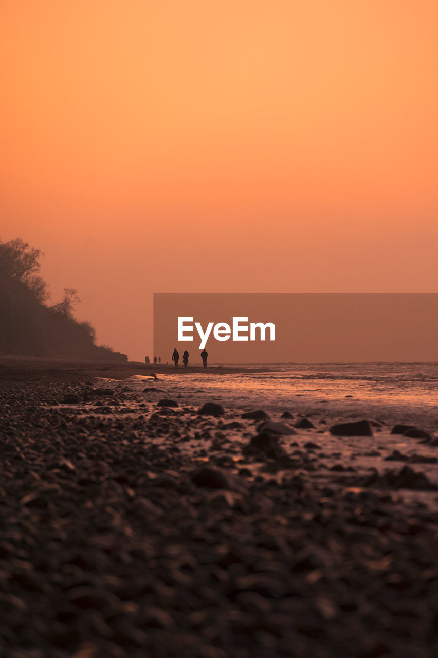 Scenic view of sea against clear sky during sunset