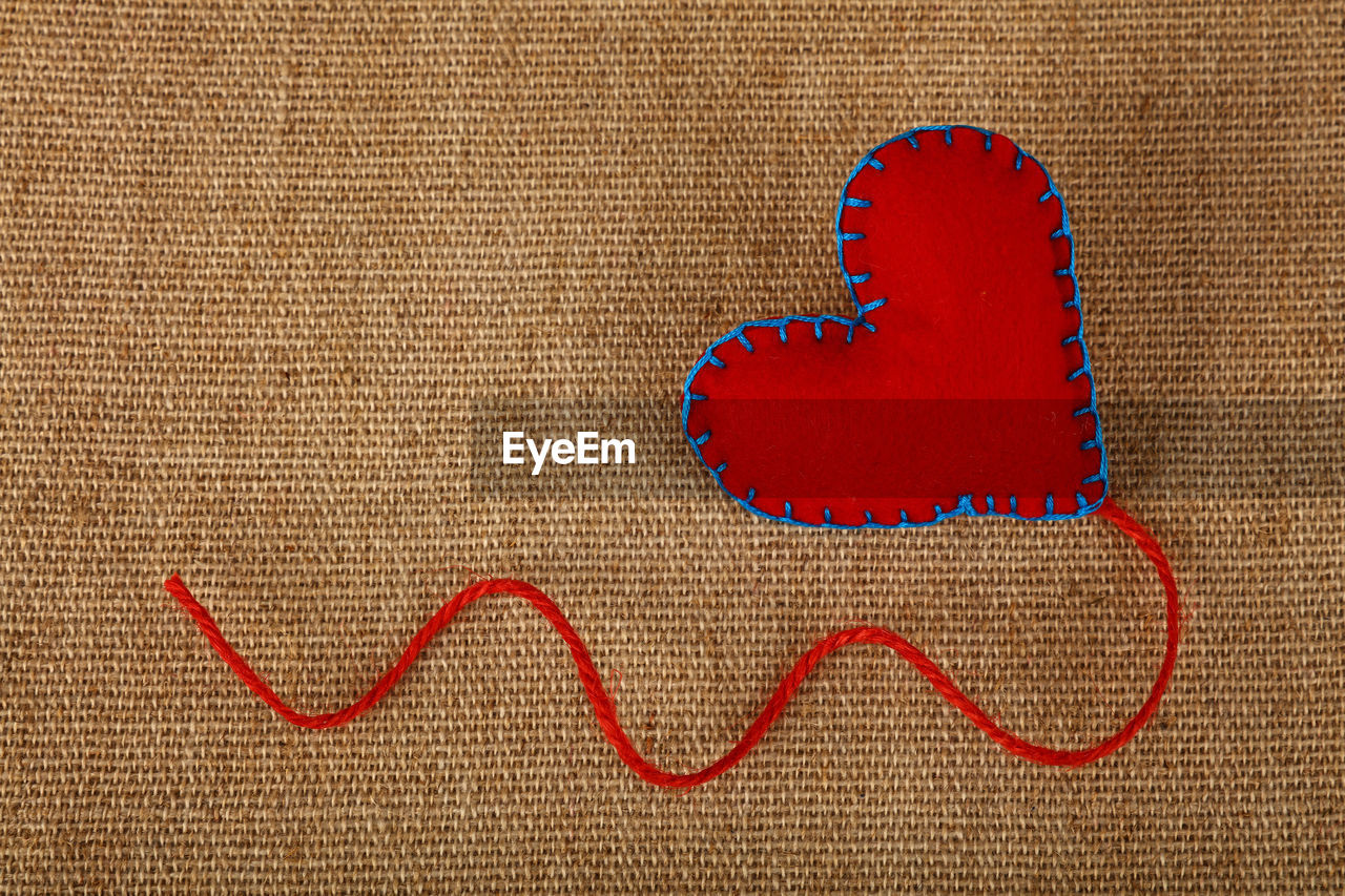 High angle view of heart shape on burlap