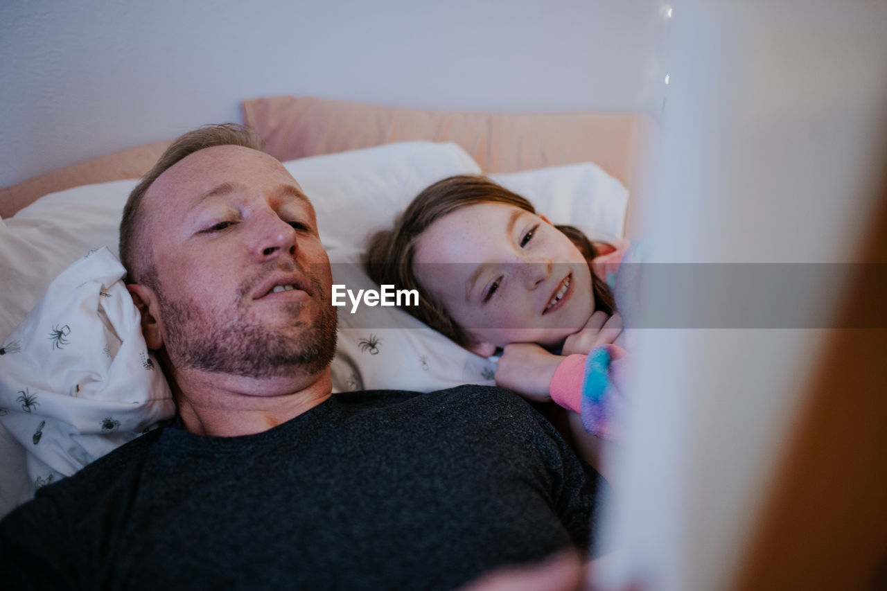 Close up of father reading to happy young daughter