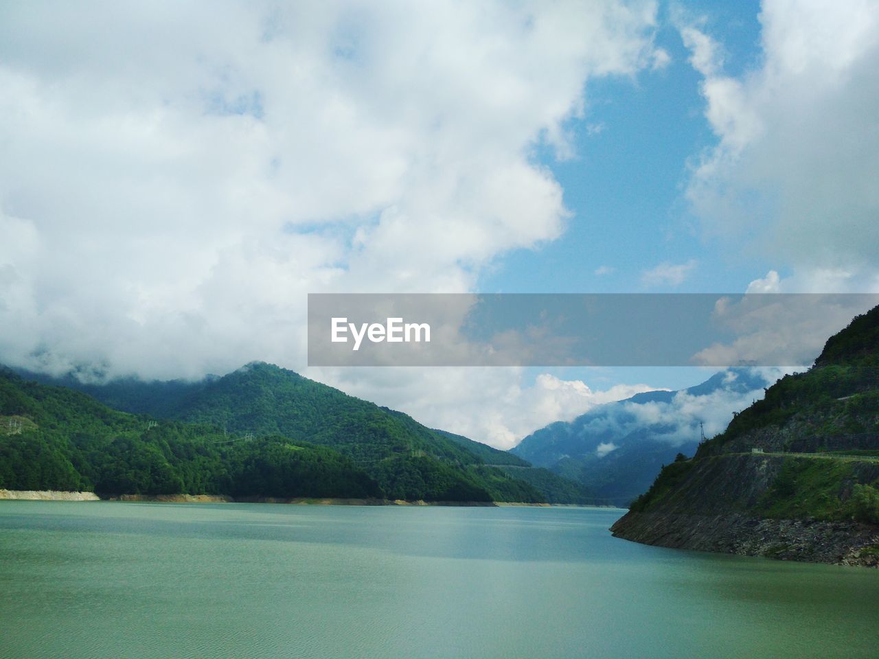 Scenic view of lake and mountains against sky