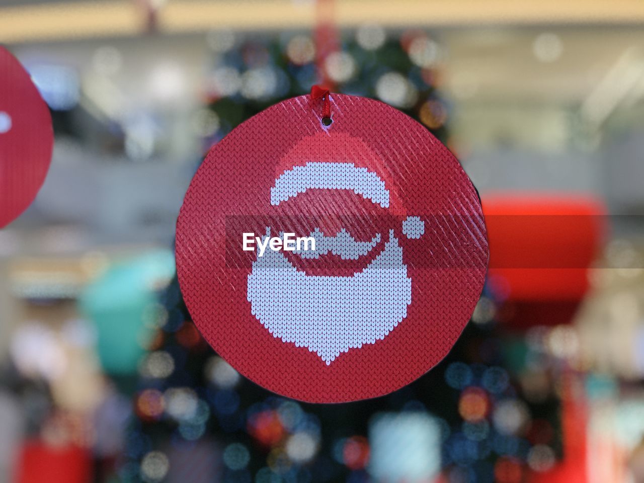 CLOSE-UP OF RED HEART SHAPE DECORATION HANGING OUTDOORS