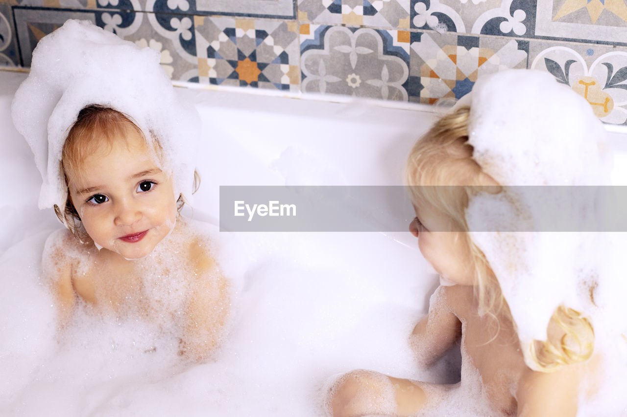 Cute girls bathing in bathtub
