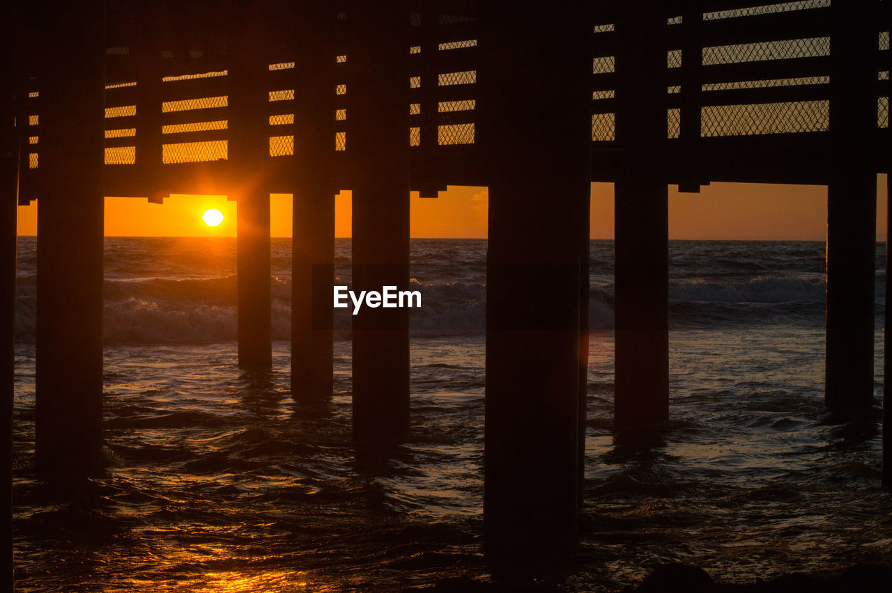 Scenic view of sea against orange sky