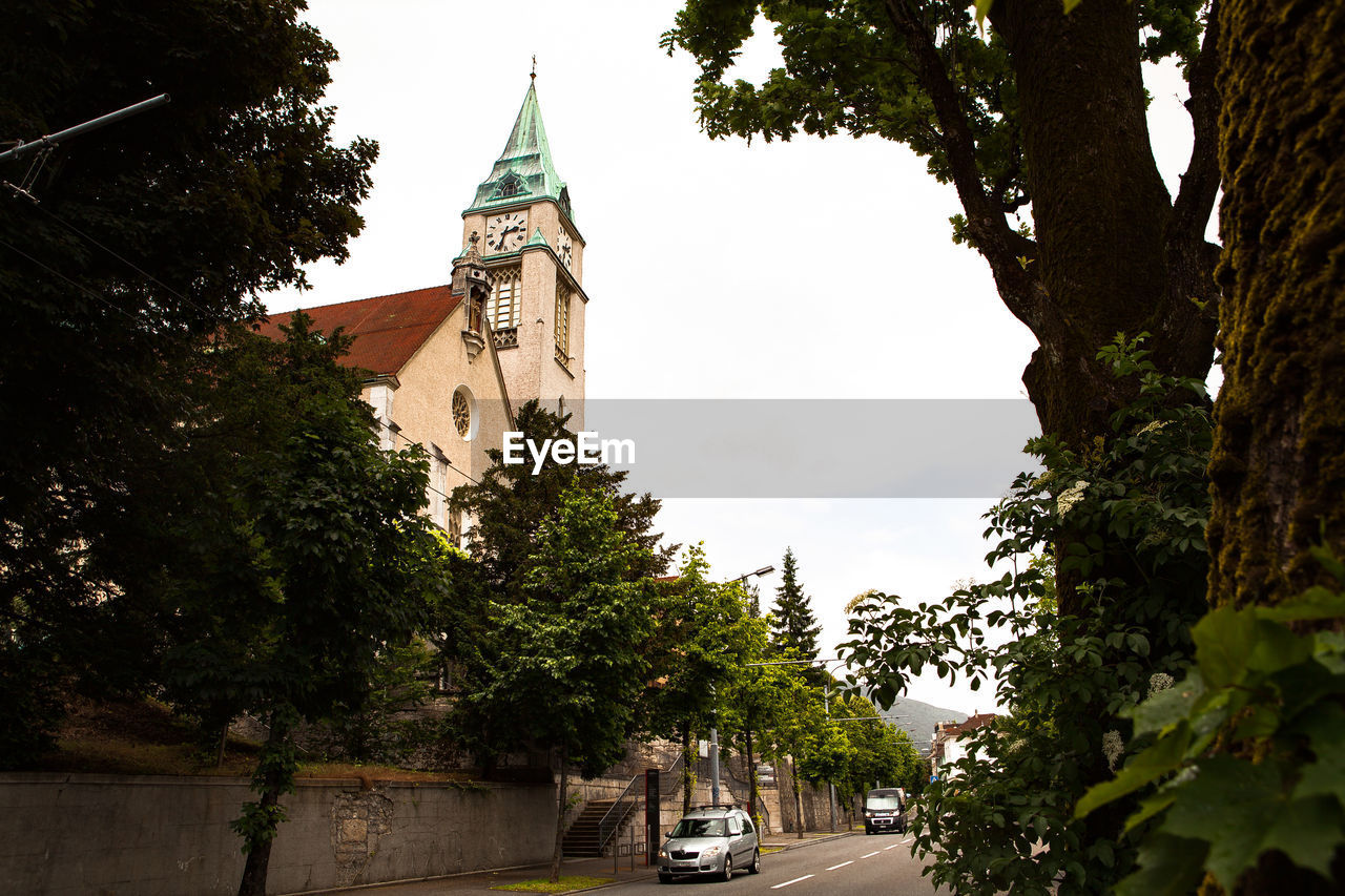 LOW ANGLE VIEW OF CHURCH WITH TREES IN BACKGROUND