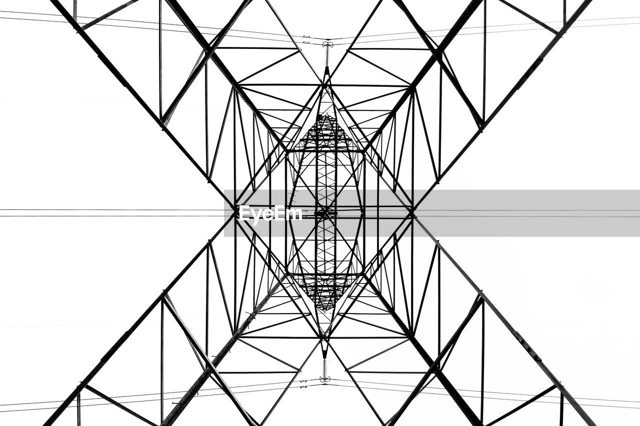 From below black and white close up of energy tower creating abstract background geometric shapes