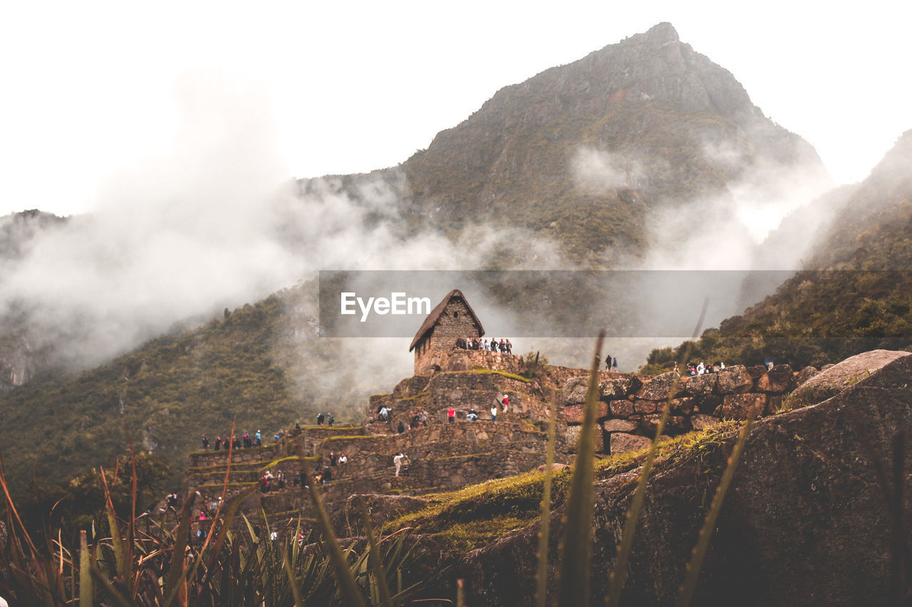 Panoramic shot of historic building against mountain range. machu picchu