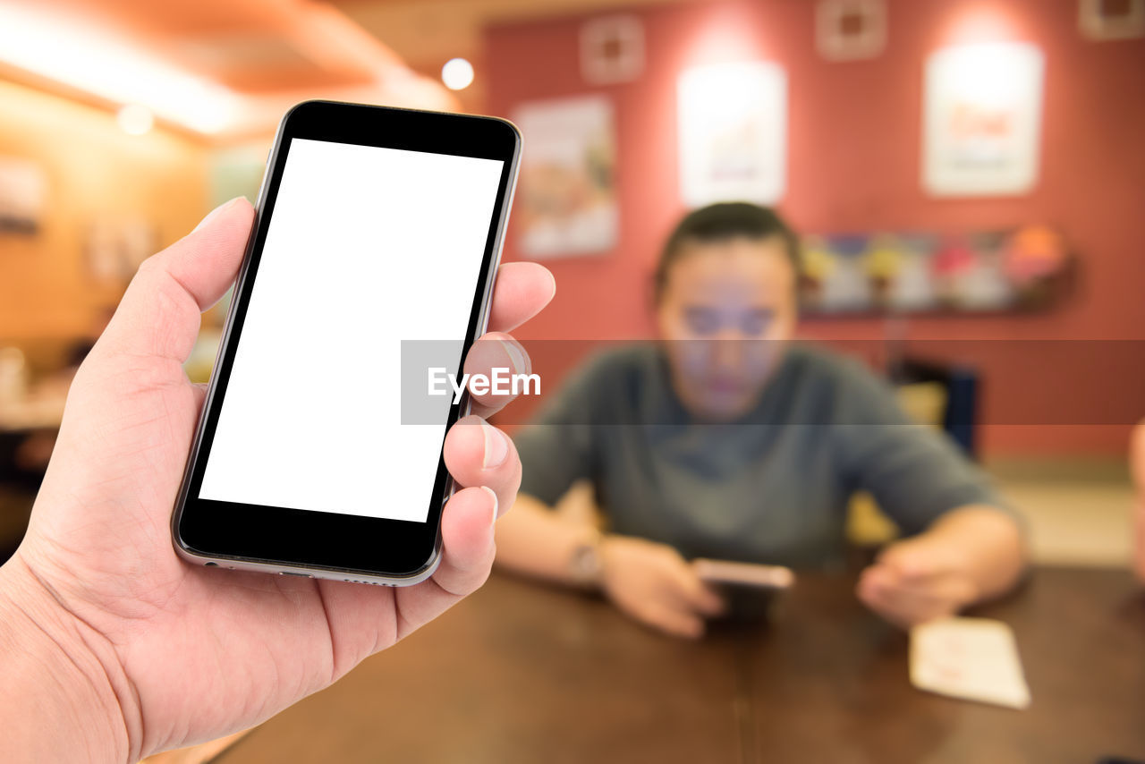 PERSON HOLDING MOBILE PHONE
