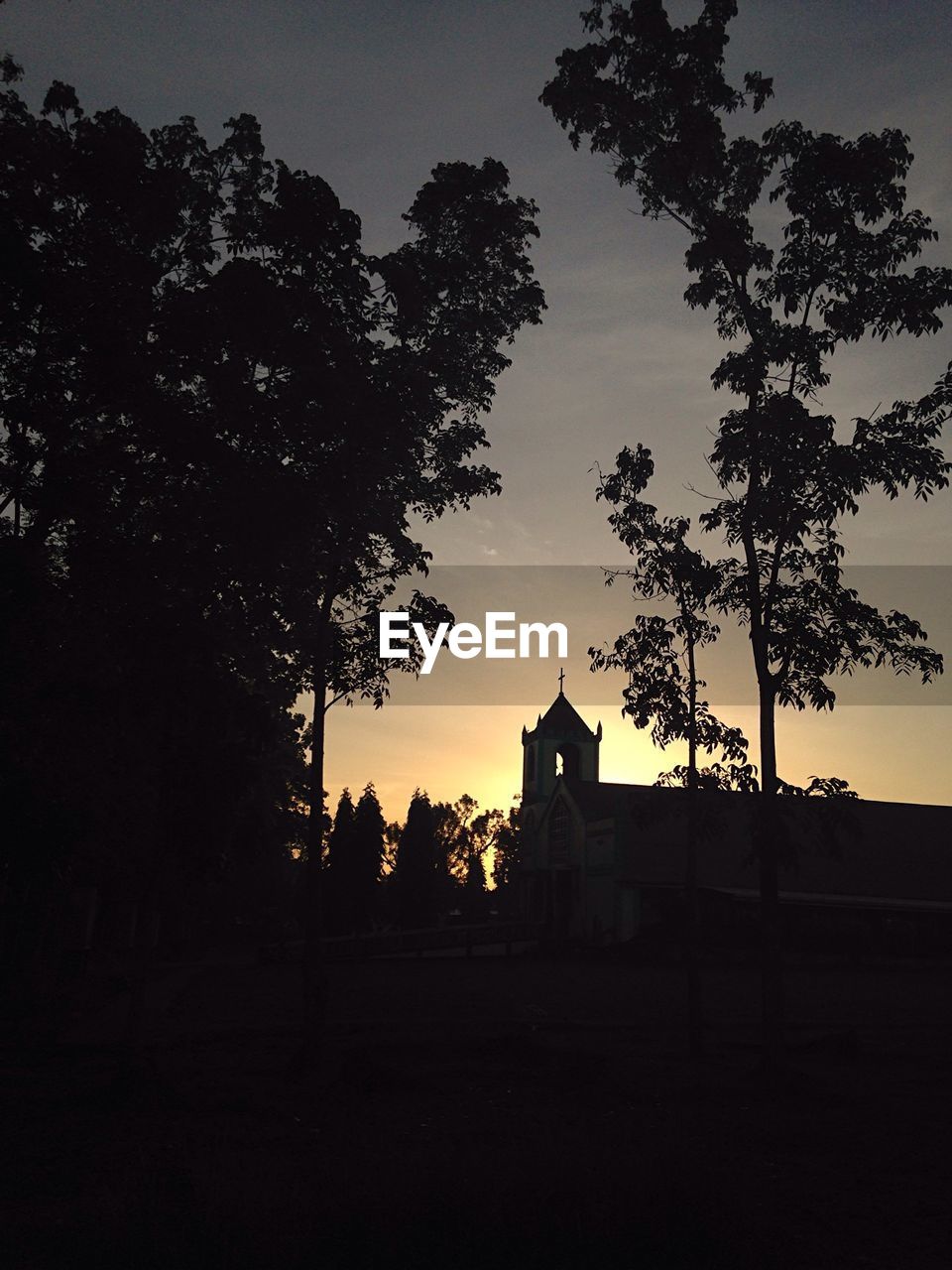 SILHOUETTE OF BUILT STRUCTURE AGAINST SUNSET