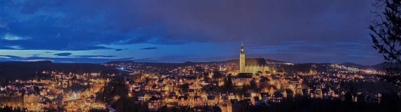 PANORAMIC VIEW OF ILLUMINATED BUILDINGS AT DUSK