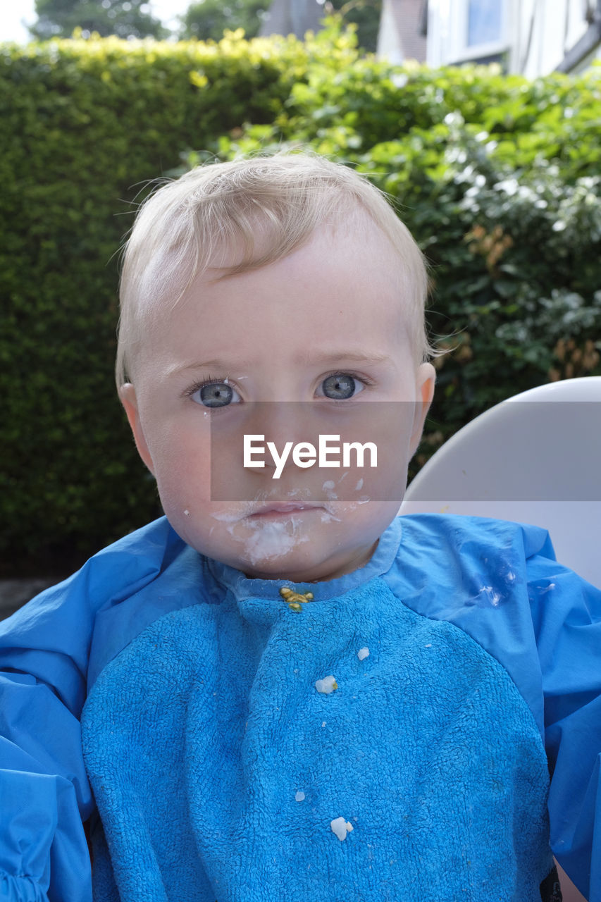 Close-up portrait of cute baby boy with dirty face