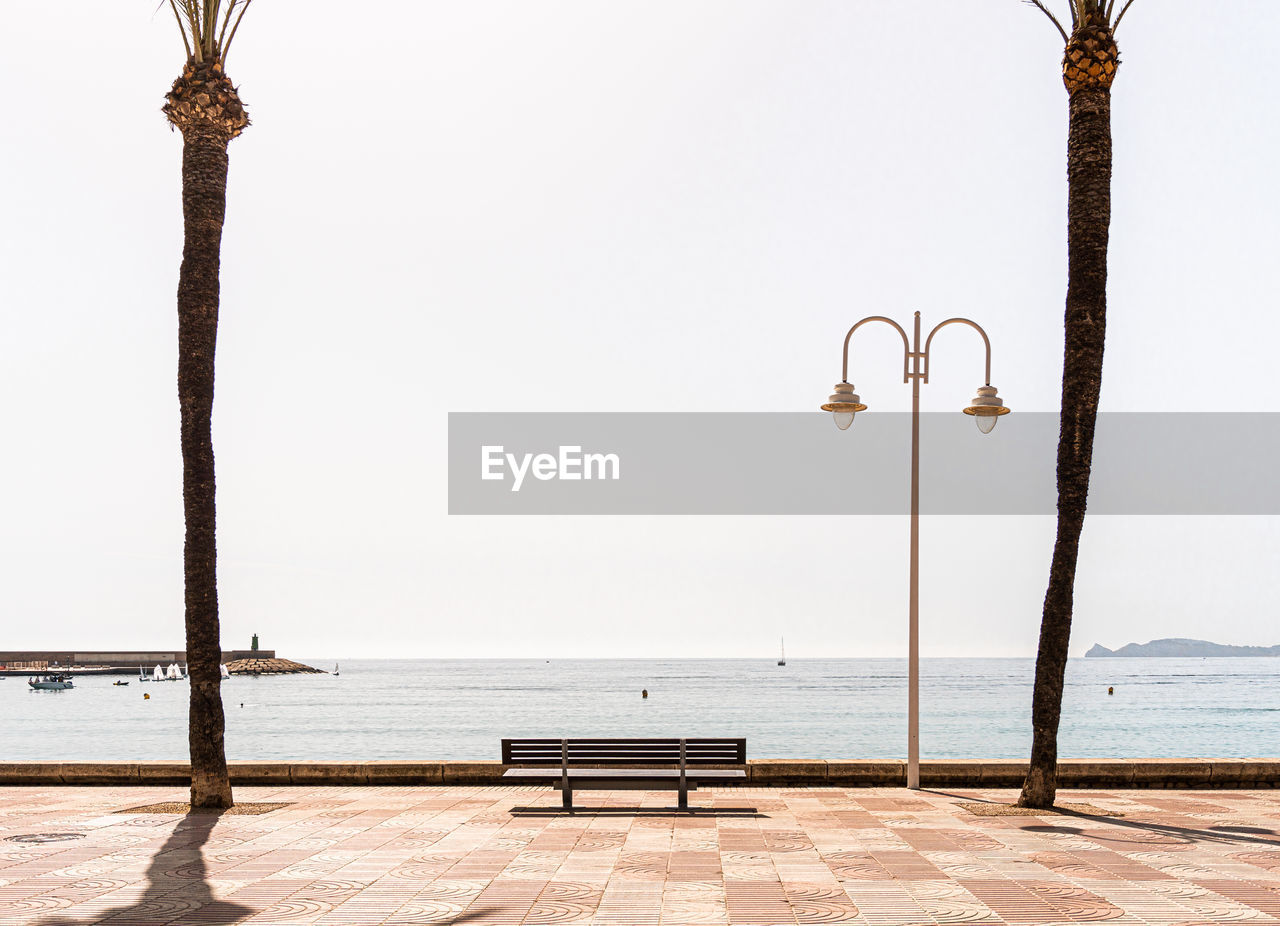 Isolated bank in front the sea in javea beach.