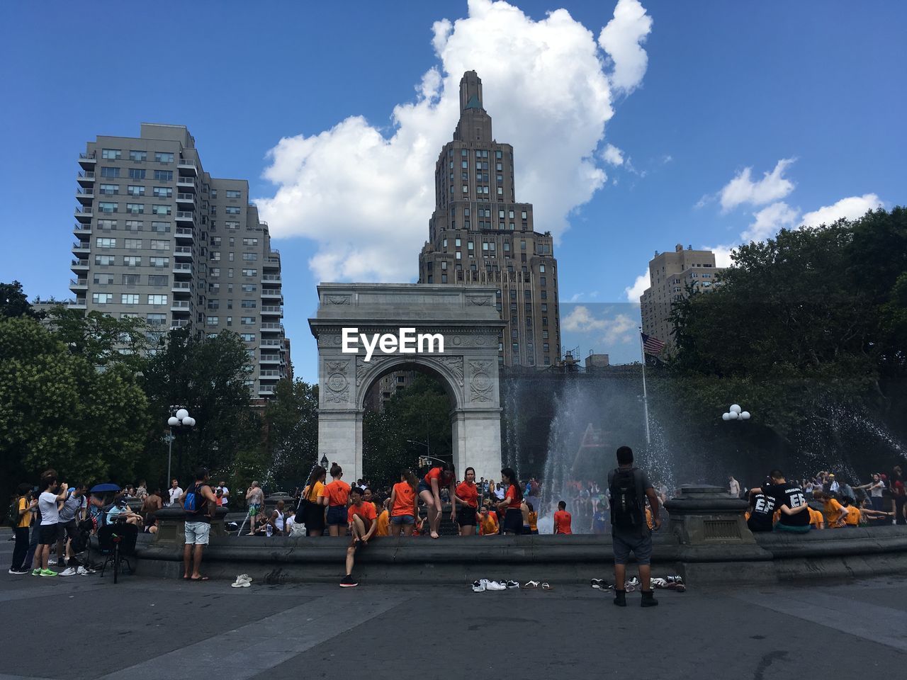 PEOPLE AT TOWN SQUARE AGAINST SKY