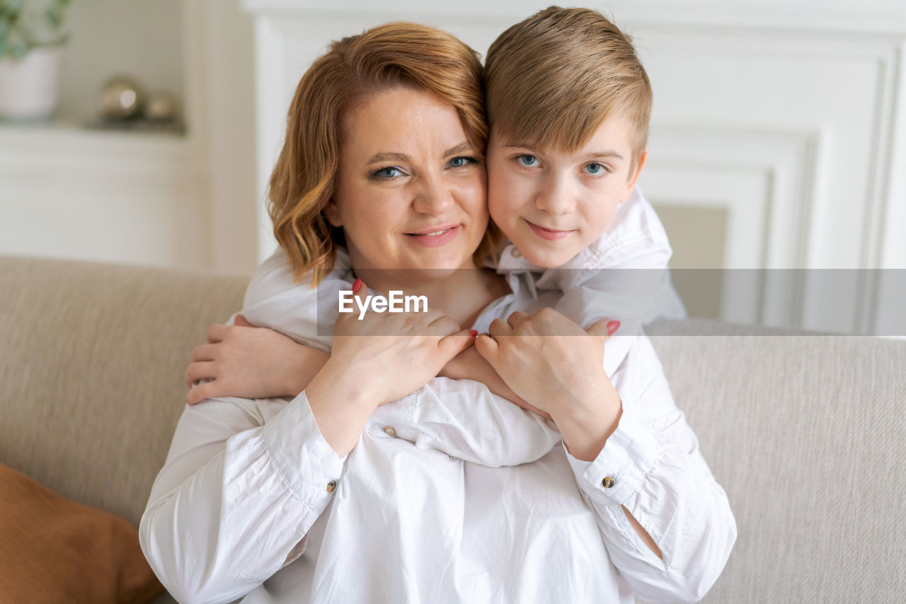 Happy woman have fun with cute baby boy 5-6-7 years old in white shirt. mom