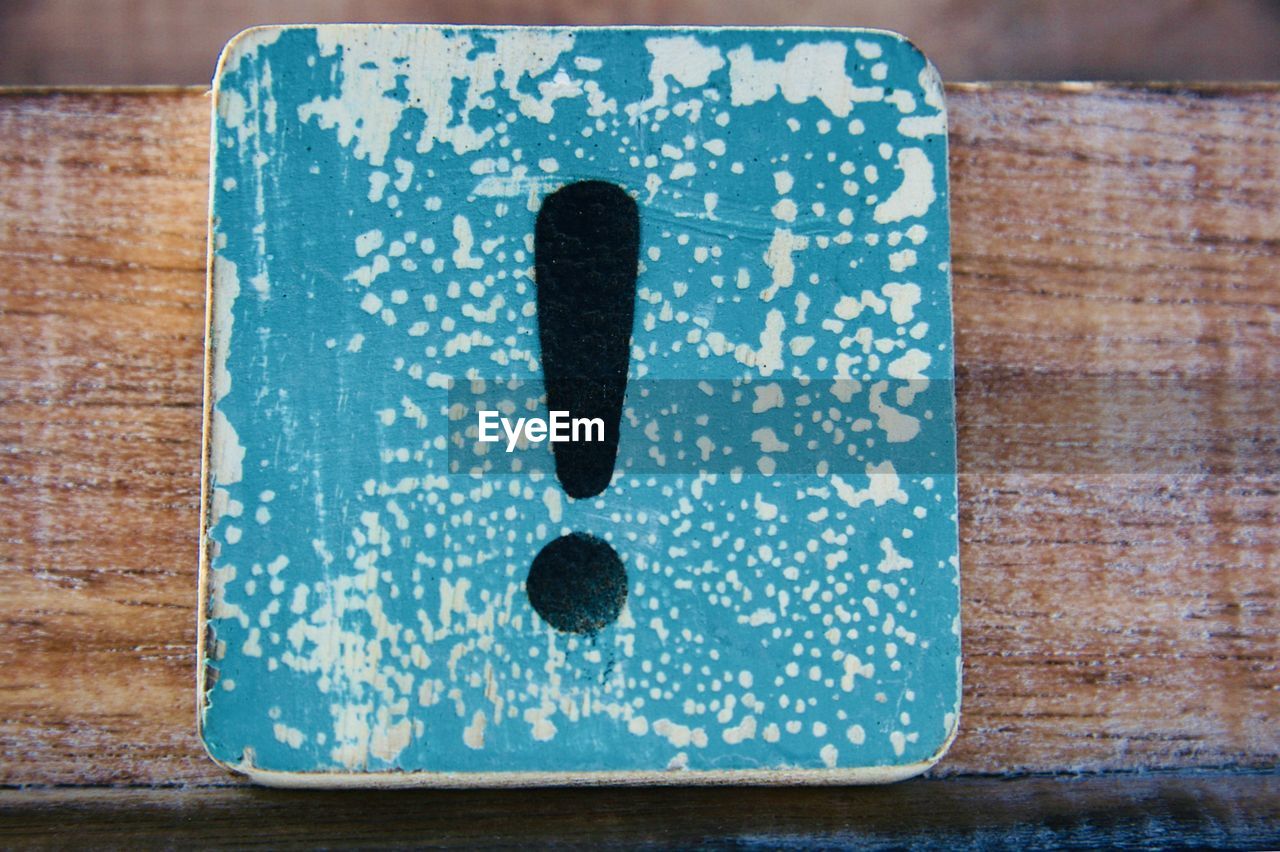 High angle view of exclamation point on table