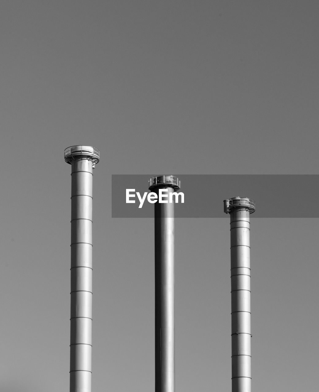 Low angle view of smoke stack against sky