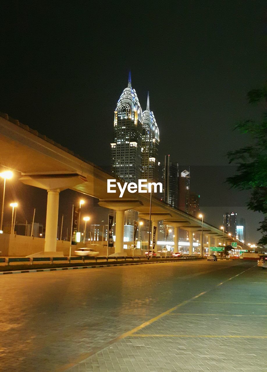 VIEW OF ILLUMINATED STREET LIGHTS AT NIGHT