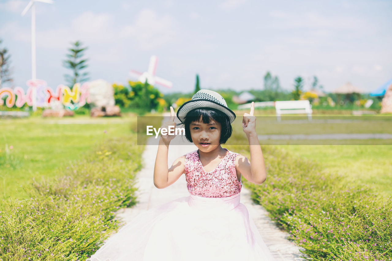 Full length of cute girl standing on field