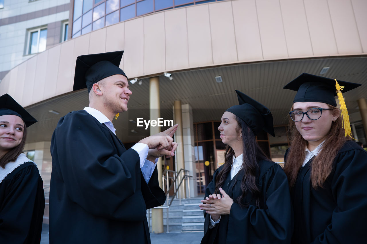 rear view of man wearing graduation gown