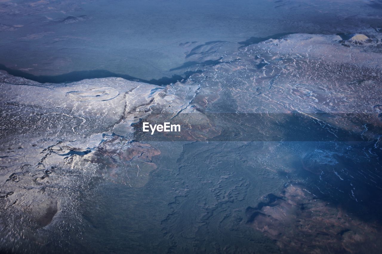 Close-up of frozen water against sky