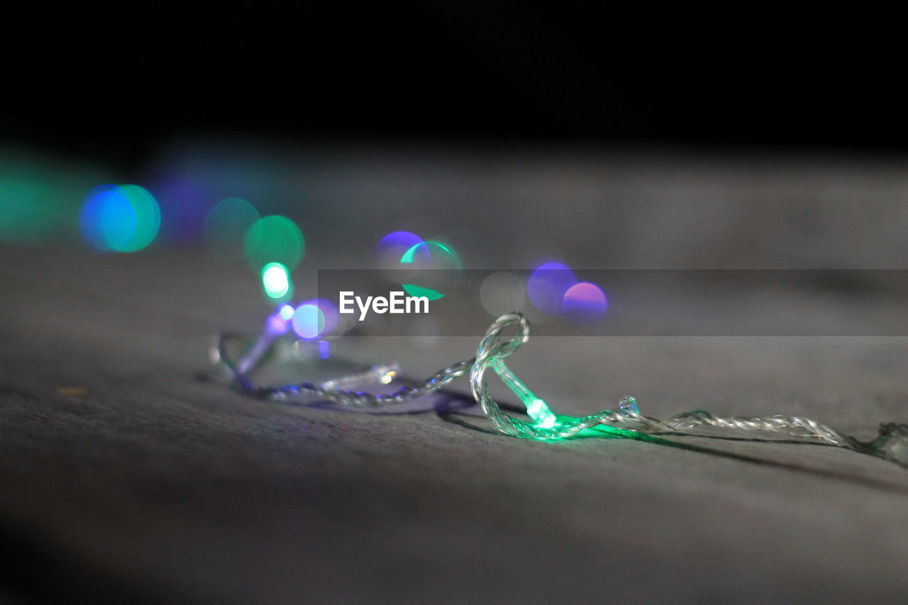 Close-up of illuminated christmas lights on table