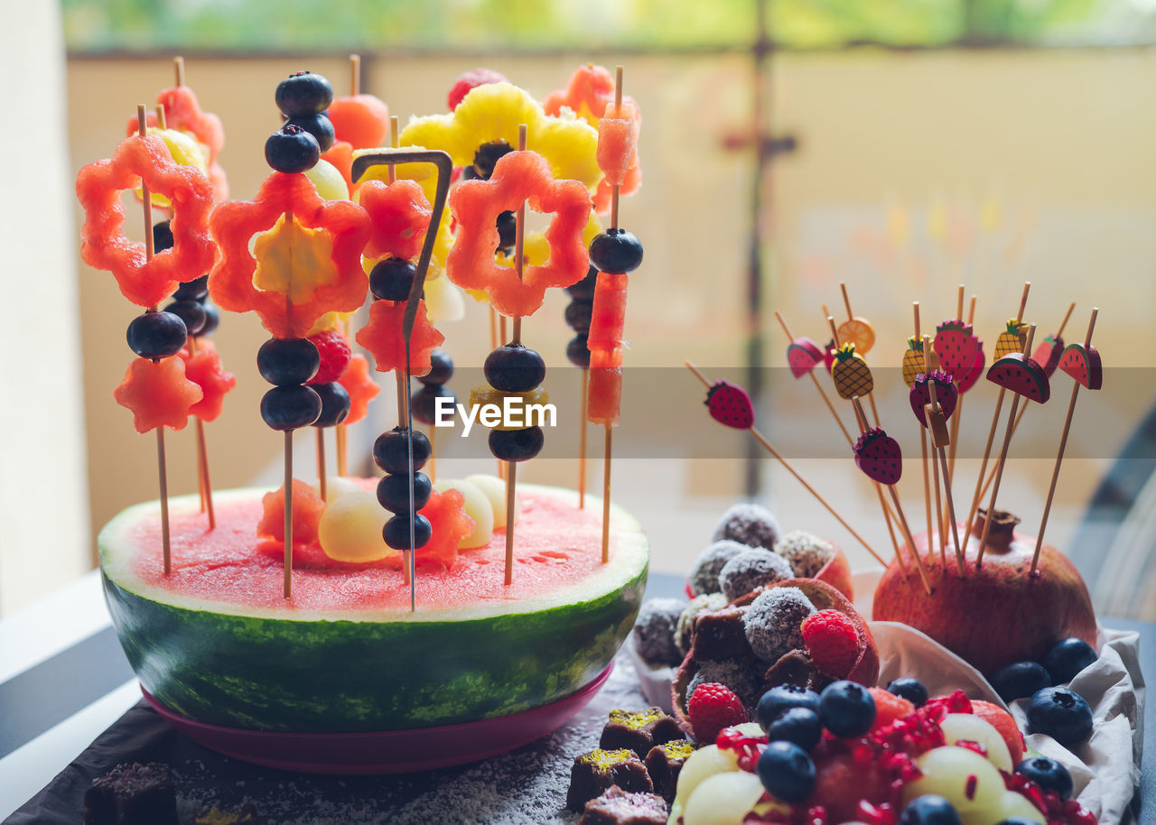 Colorful fruit dessert for a child's birthday. various shapes of fruit are put on toothpicks. 
