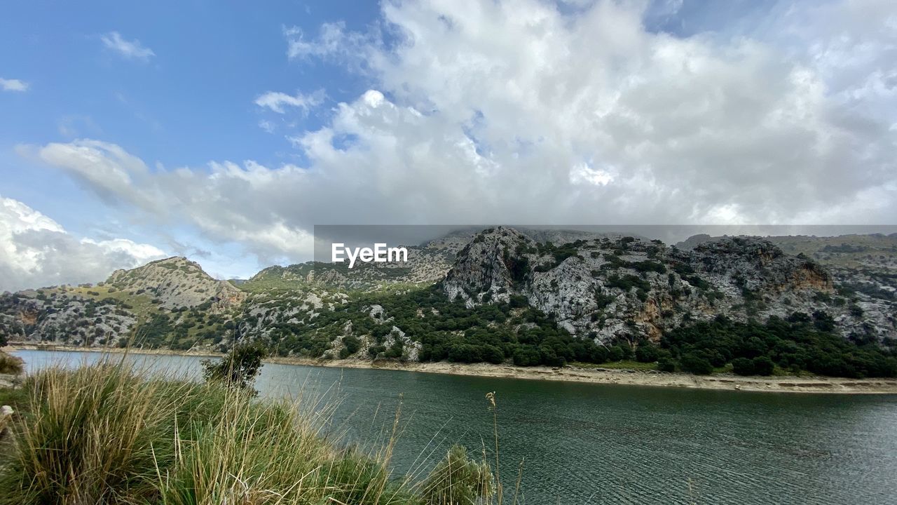 Scenic view of lake and mountains against sky