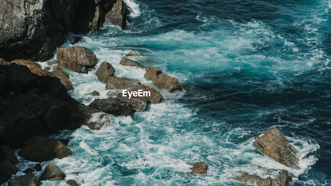 High angle view of rocks in sea