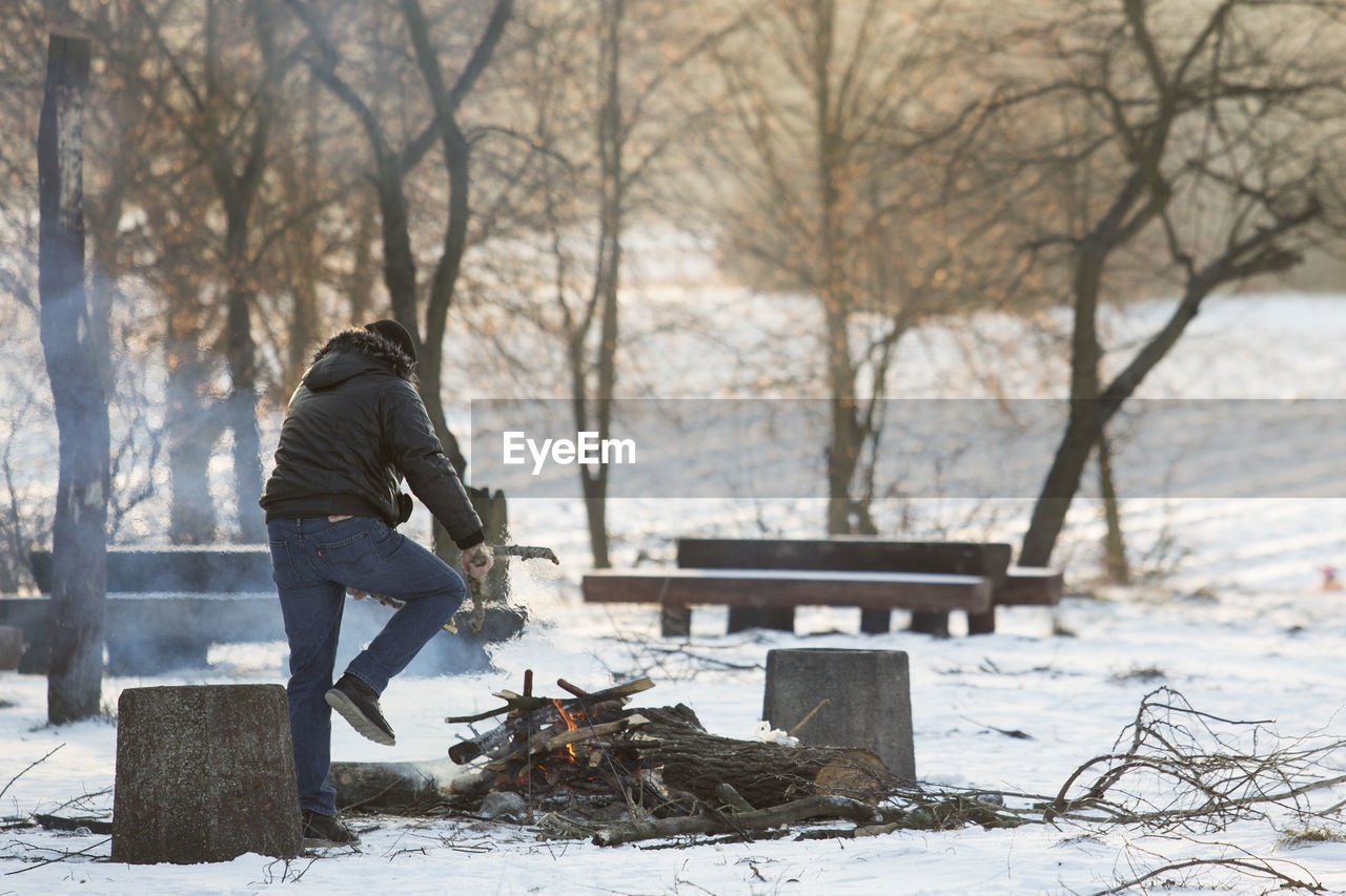 Man working on snow covered tree