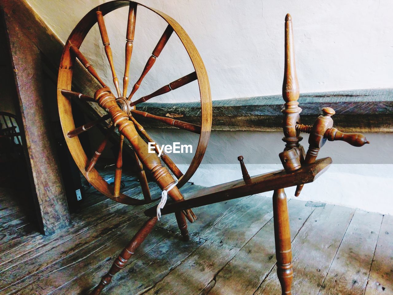 HIGH ANGLE VIEW OF RUSTY WHEEL ON WOOD