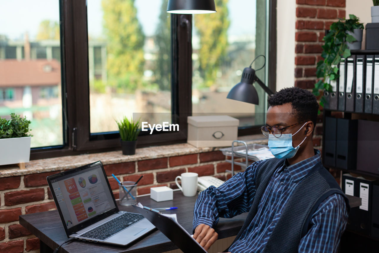 Businessman wearing mask working at office