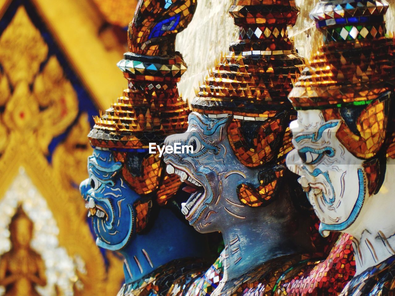 Close-up of statues of demons in buddhist temple