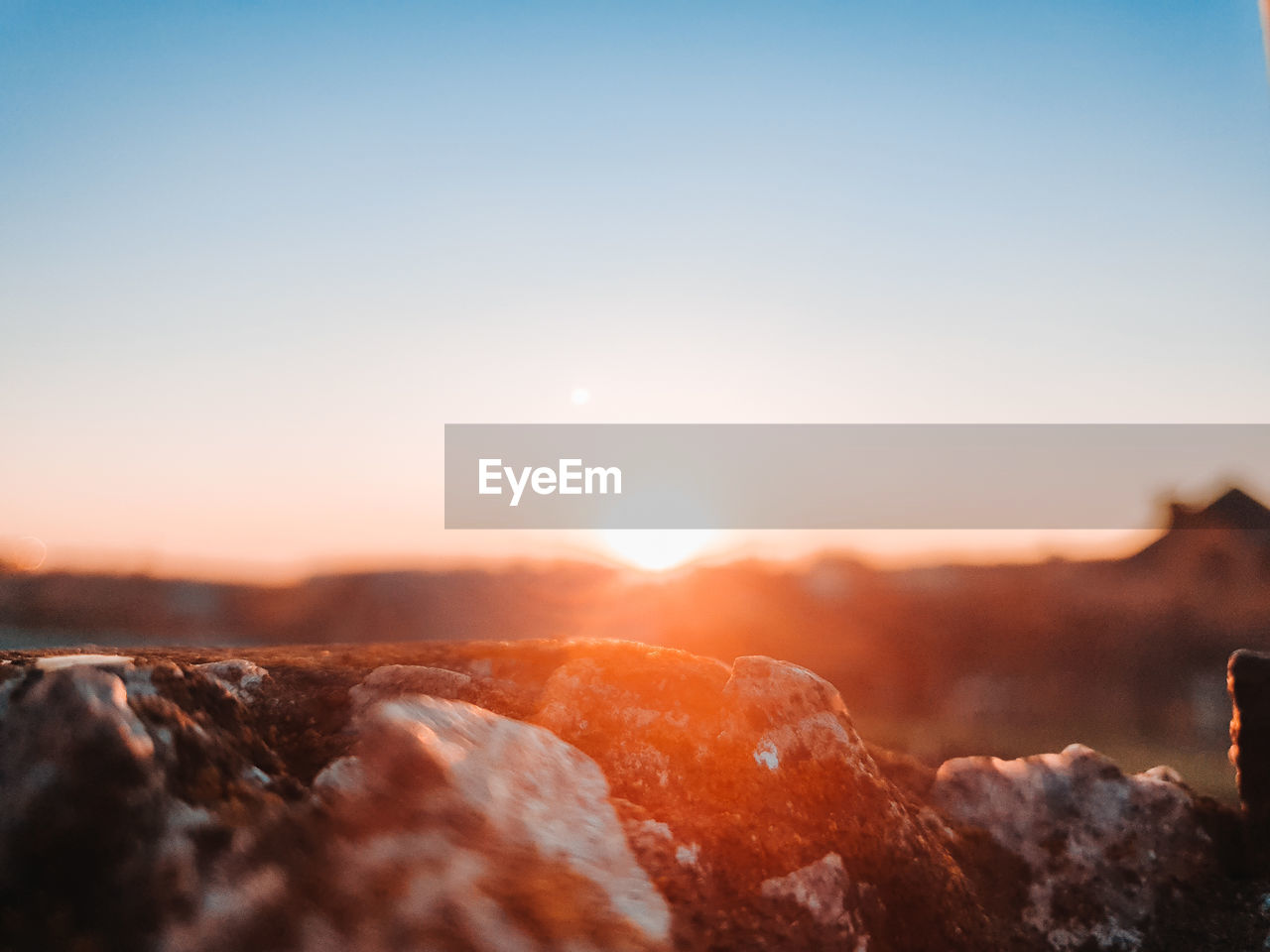 Scenic view of rocks against sky during sunset