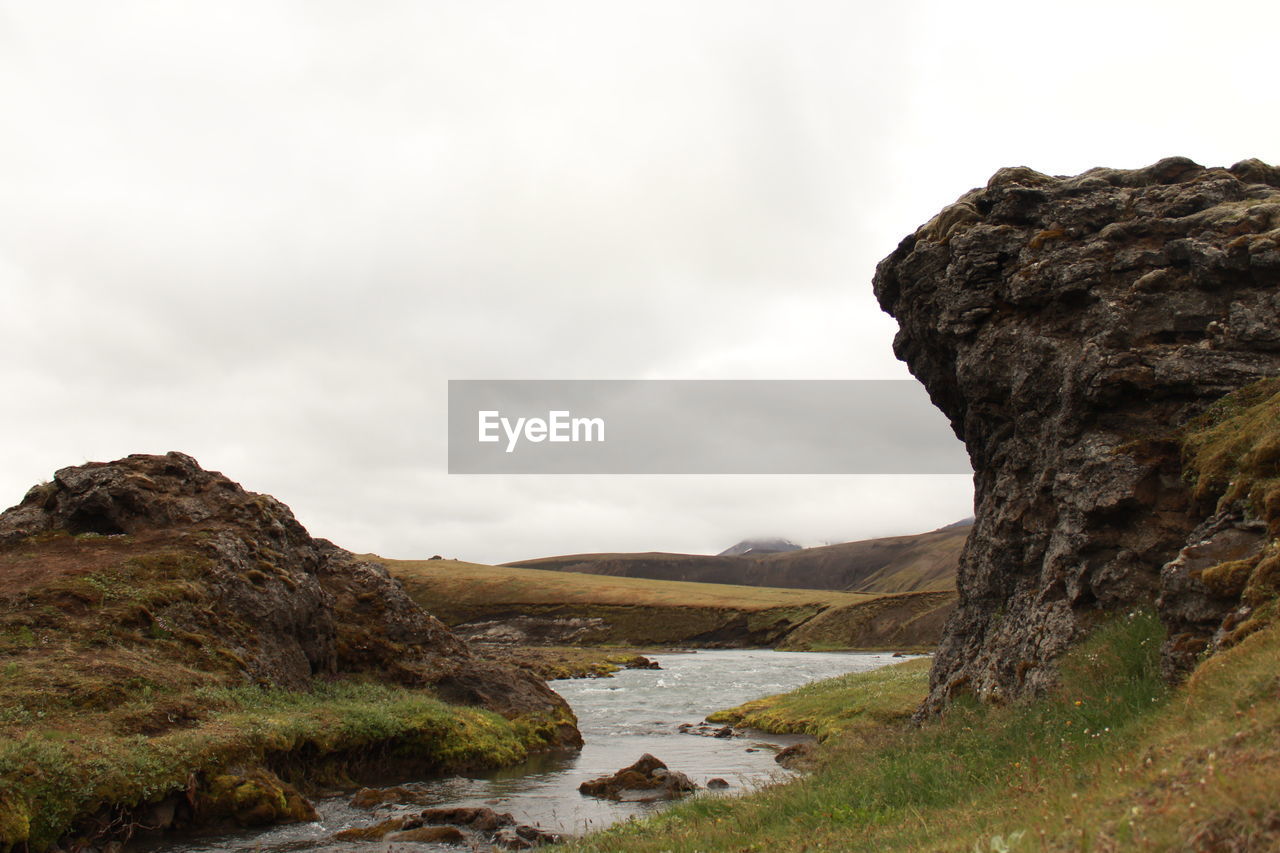 Scenic view of rocks and mountains against sky