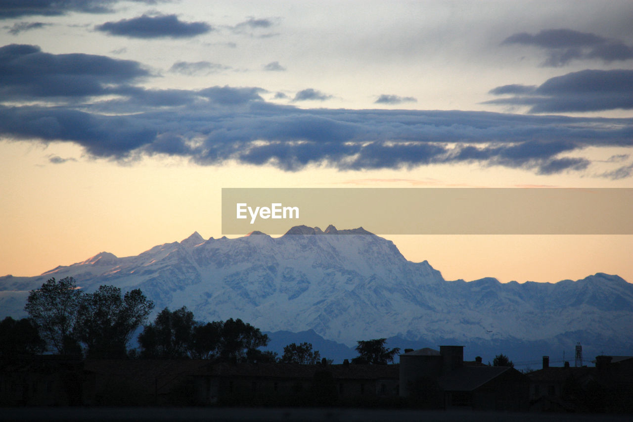 Scenic view of silhouette mountains against sky at sunset