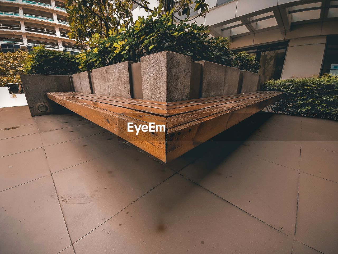 POTTED PLANT ON TILED FLOOR BY BUILDING