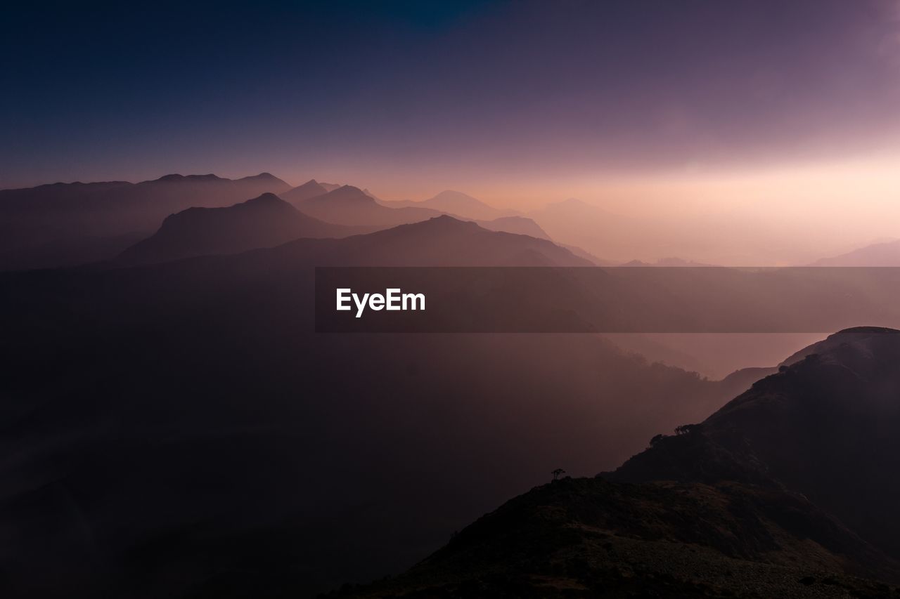 SCENIC VIEW OF MOUNTAINS AGAINST SKY DURING SUNSET