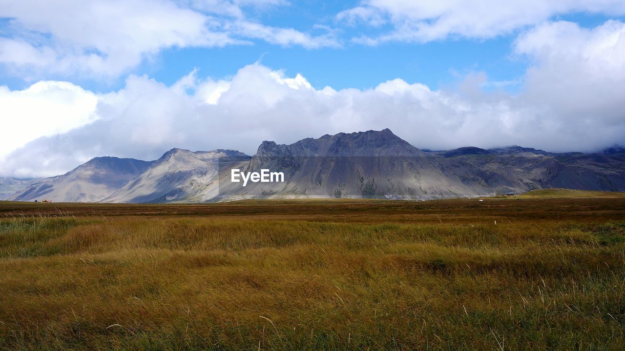 VIEW OF COUNTRYSIDE LANDSCAPE AGAINST CLOUDS