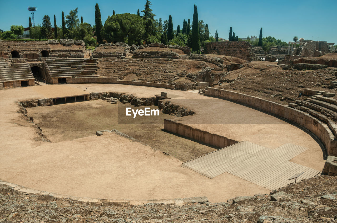 Stone bleachers and arena in the roman amphitheater at the archaeological site of merida, spain.