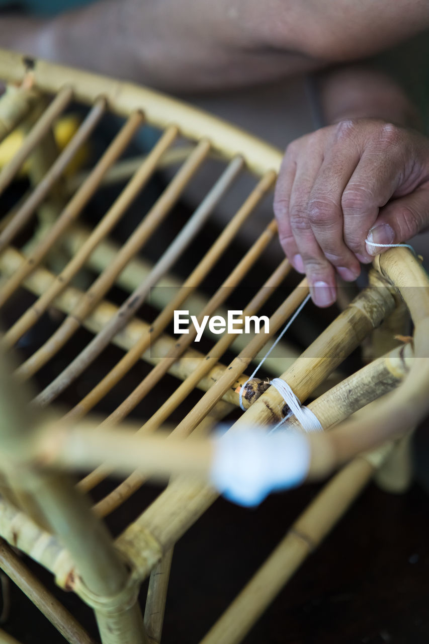 Close-up of man making wooden chair