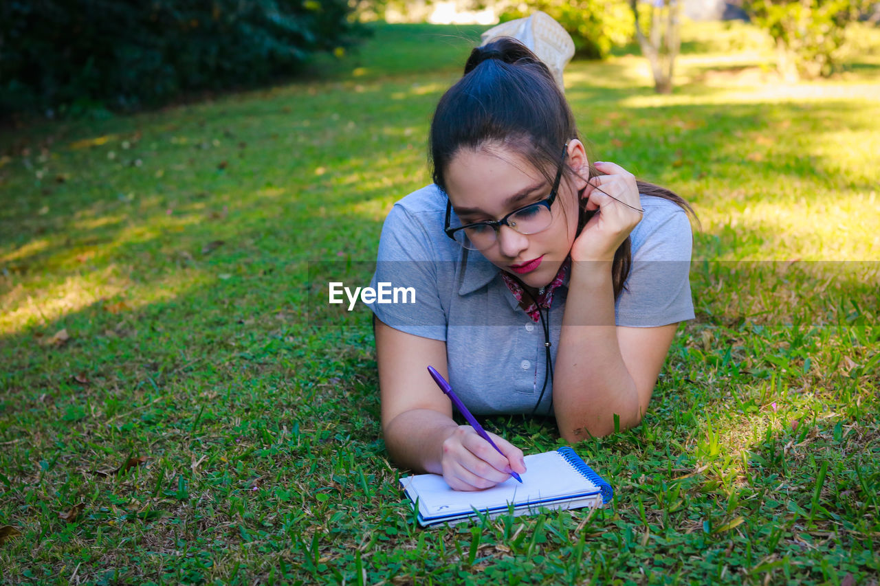 Young woman studying at park