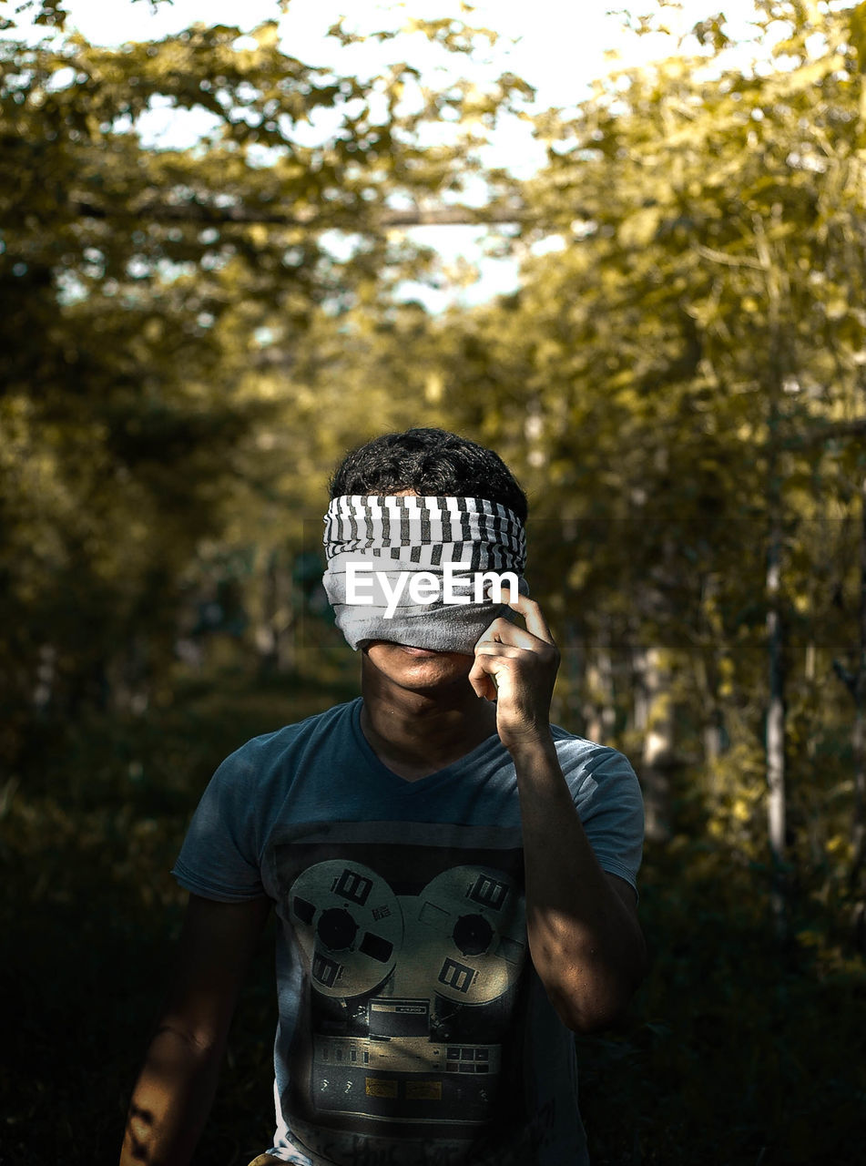 Man covering face with fabric