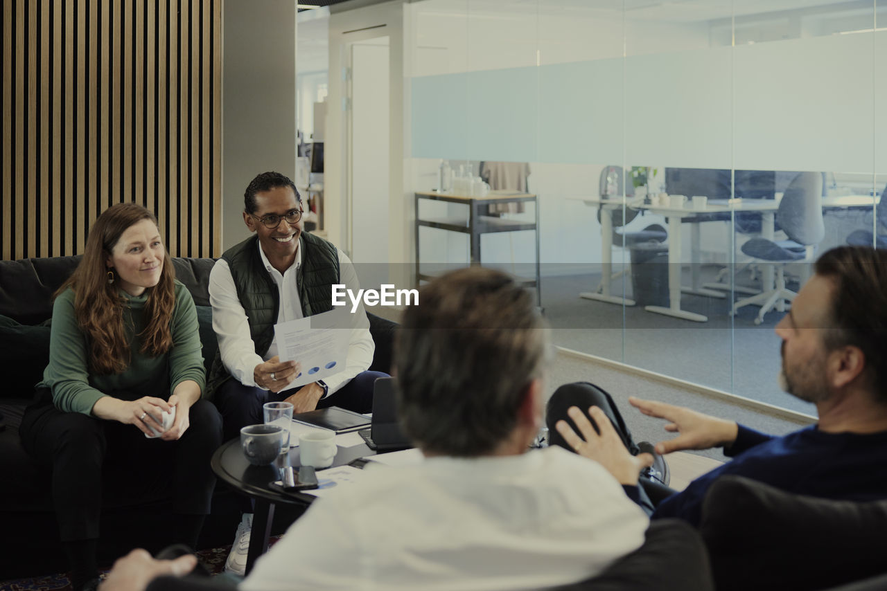 Group of business people having meeting in lobby